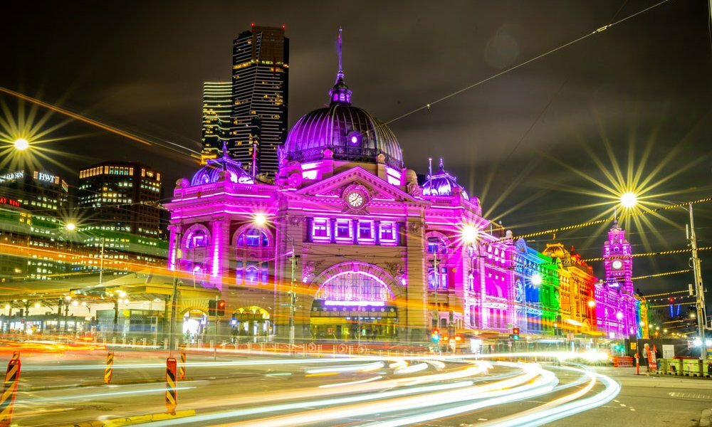 A train station lit up in rainbow lights