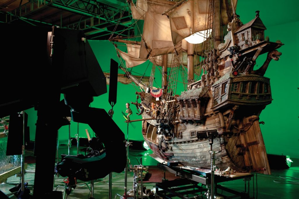 Pirate ship sits in a studio in front of a green screen.