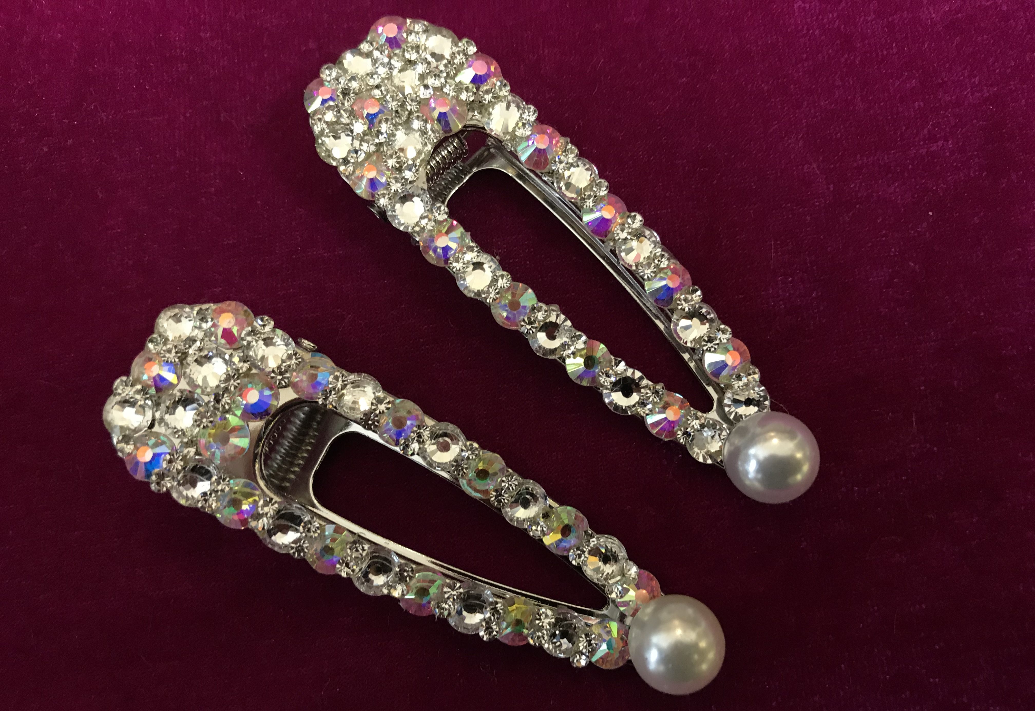 Two hair clips adorned with rhinestones and pearls