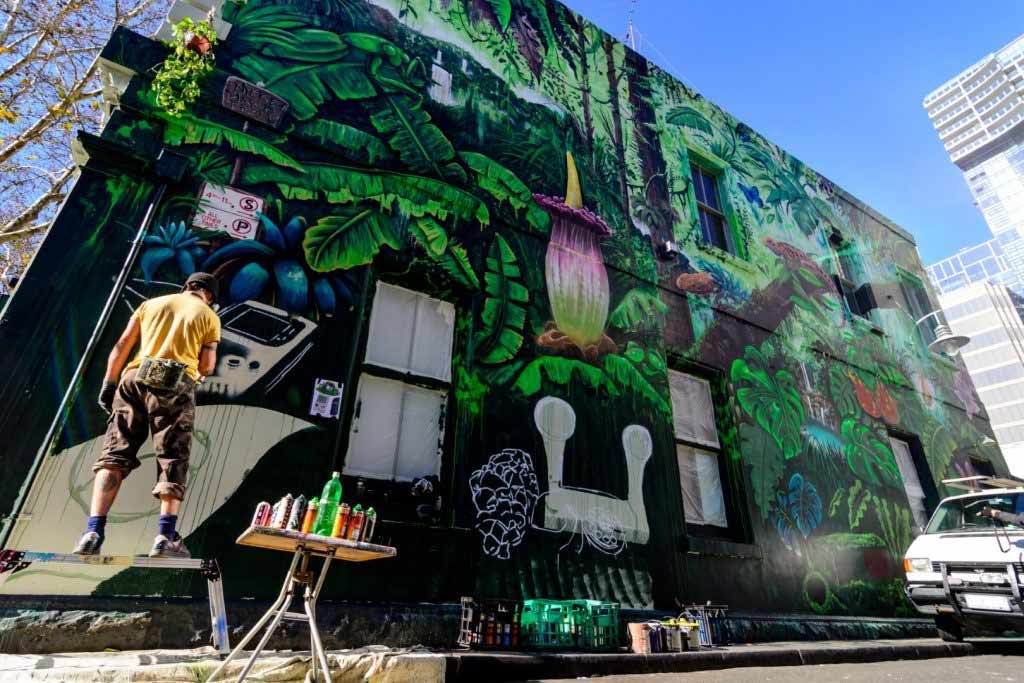A leafy street art mural on a large wall