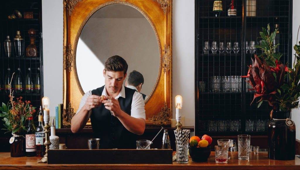  A bartender mixing a drink behind the bar