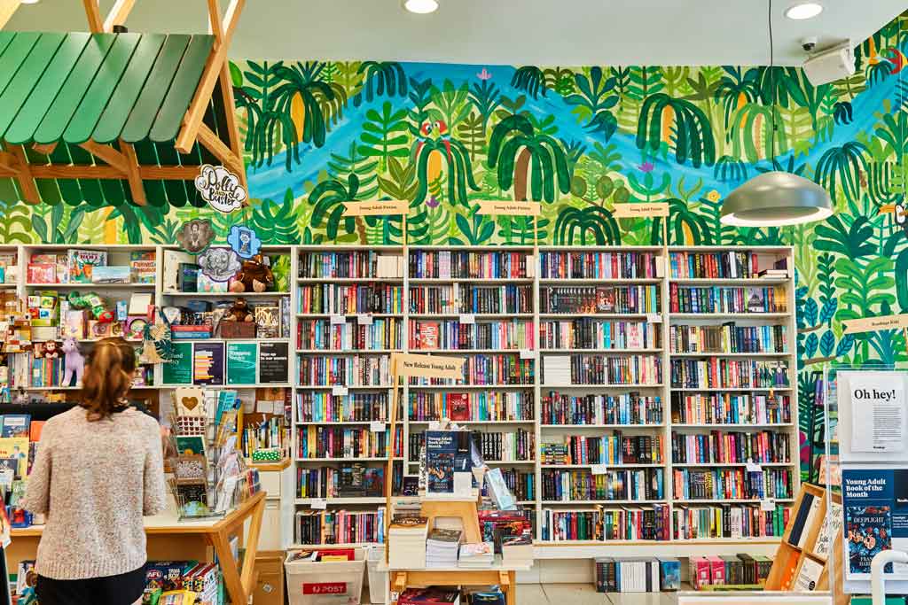 A brightly coloured store with book filled shelves